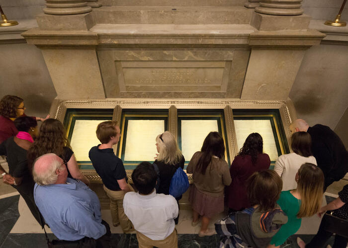 Group of people looking at the Constitution