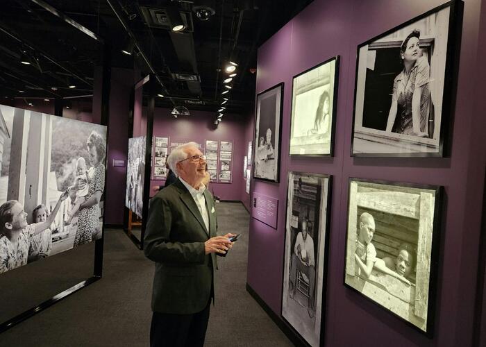 Man looking at pictures on display in exhibit