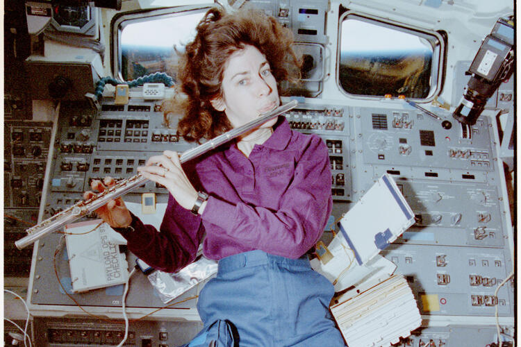 Mission Specialist Ellen Ochoa playing a flute
