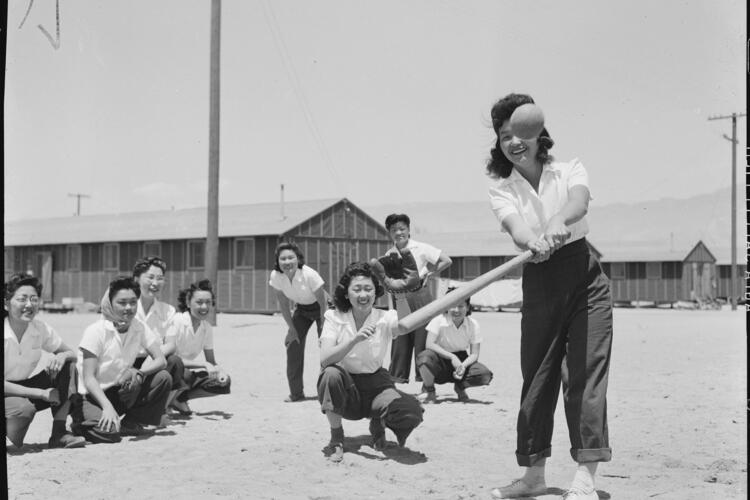 Manzanar Relocation Center, Manzanar, California. May Noma behind the plate and Tomi Nagao at bat . . ., May 30, 1942