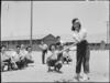 Manzanar Relocation Center, Manzanar, California. May Noma behind the plate and Tomi Nagao at bat . . ., May 30, 1942