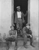 Three men in doorway of lamp house