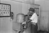 Man drinking from water fountain.
