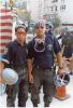 New York police officers are seen holding hard hat helmets following the attacks on September 11, 2001