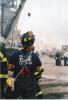 A New York firefighter looks into the smoky distance following the attacks on September 11, 2001