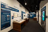 Color photograph of exhibit gallery with exhibit cases and text labels