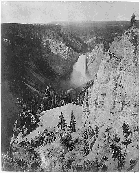 Black and white image of a waterfall among mountains