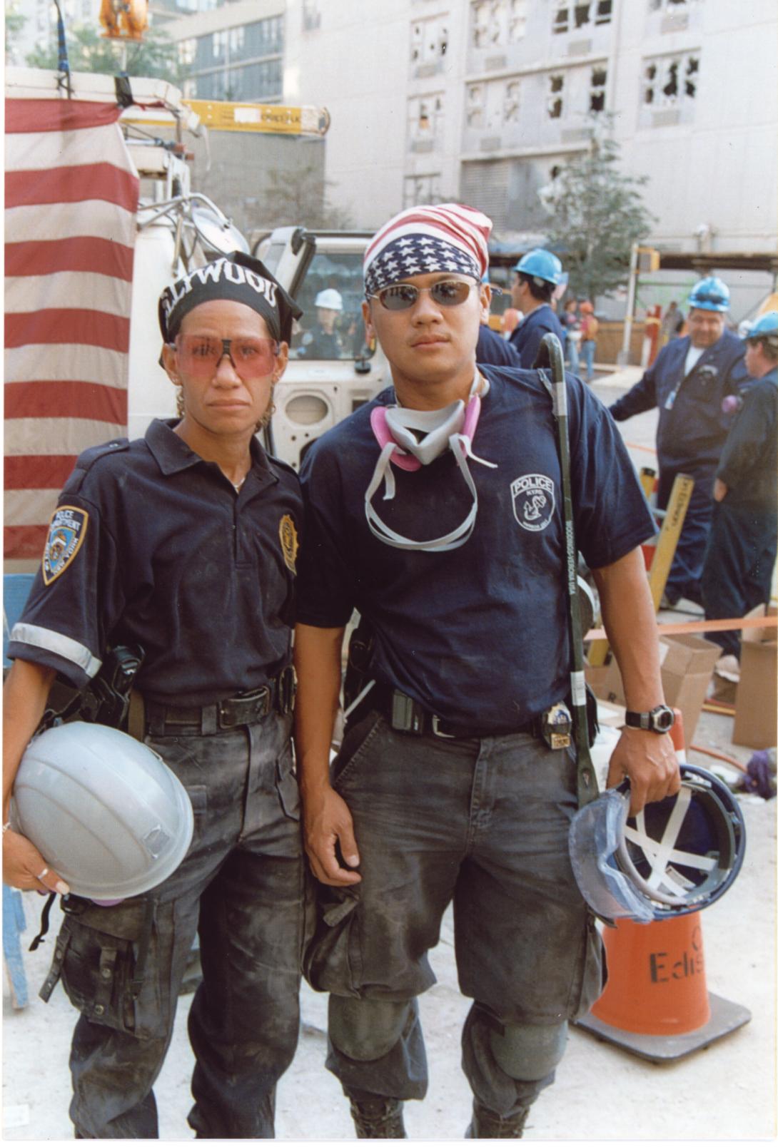 New York police officers are seen holding hard hat helmets following the attacks on September 11, 2001