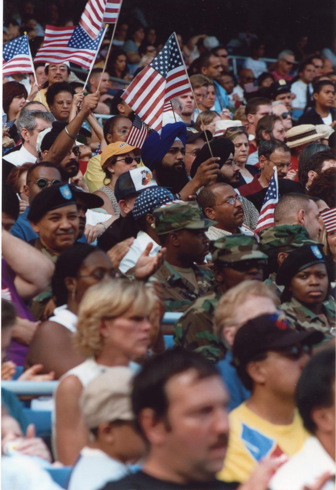 A crowd forms waving American flags following the attacks on September 11, 2001 in New York City.