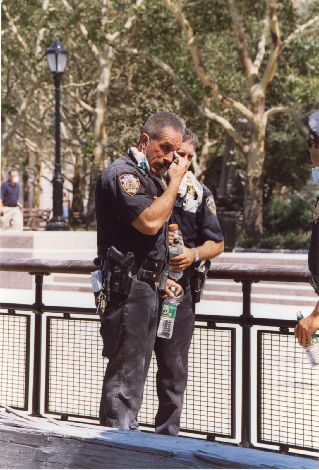 A New York police officer wipes their eyes following the attacks on September 11, 2001.
