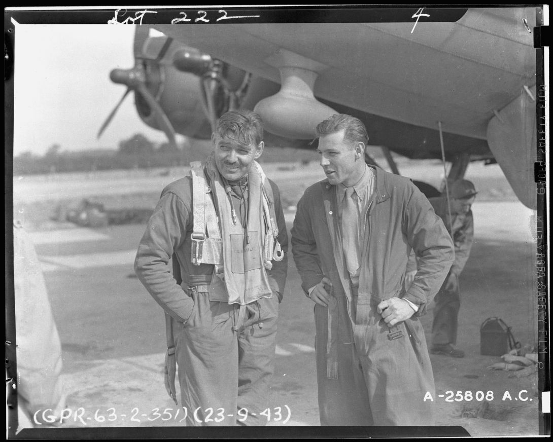 Clark Gable in flight suit with another aviator.