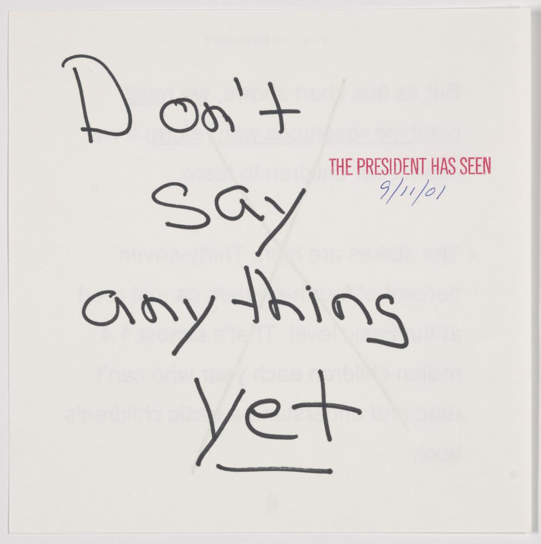 A note that says "Don't say anything yet," with "yet" underlined, handed to President George W. Bush when he learned of the attacks on September 11, 2001