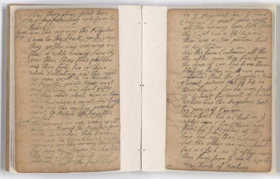 Tan two-page journal with black handwritten ink.