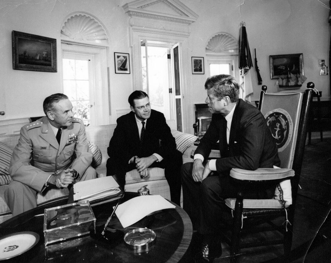 Black and white photograph of three men in the oval office