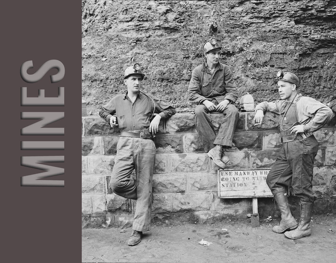 Miners leaning against wall