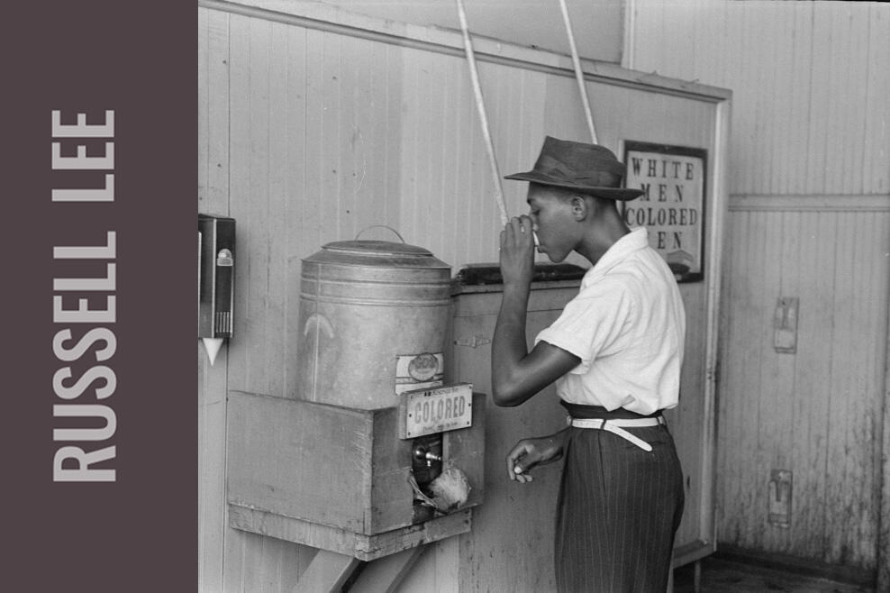 Man getting a drink from a water fountain.